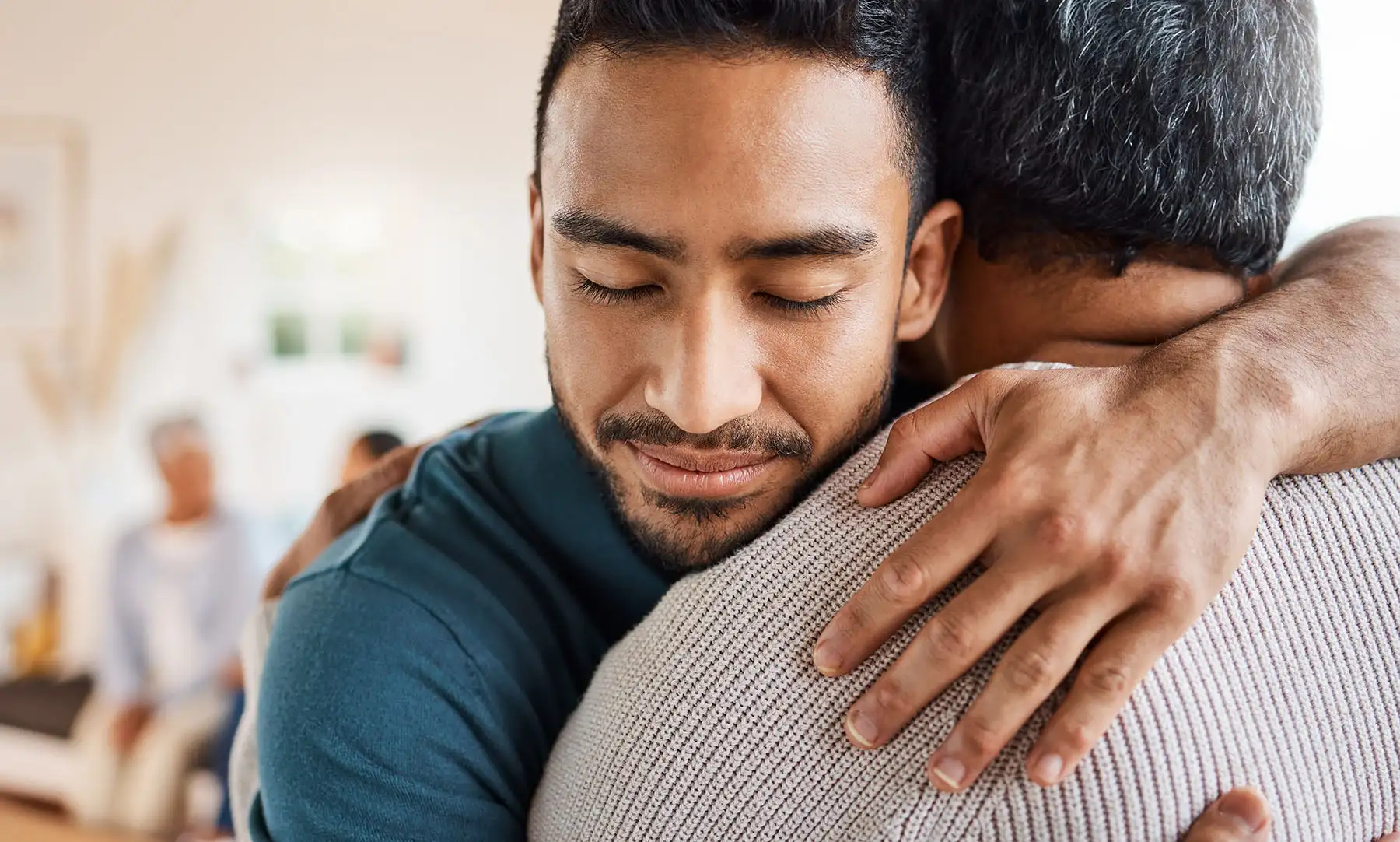 Two men hugging each other